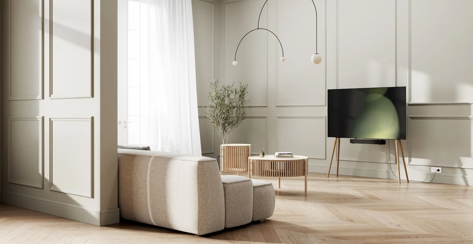 Câbles regroupés dans une gaine textile discrète le long d'un meuble télé